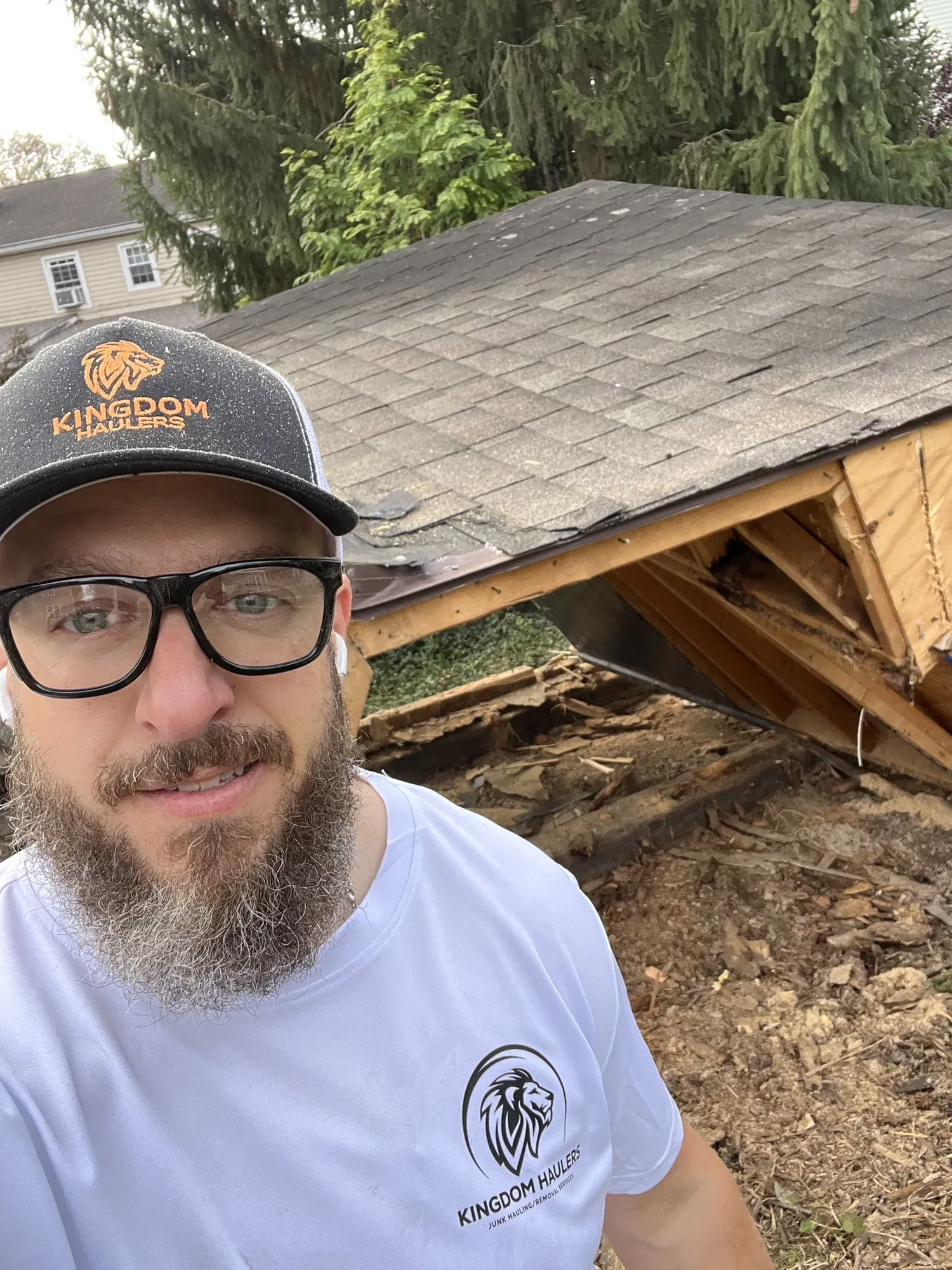 Mike from Kingdom Haulers in front of a half-demolished backyard shed