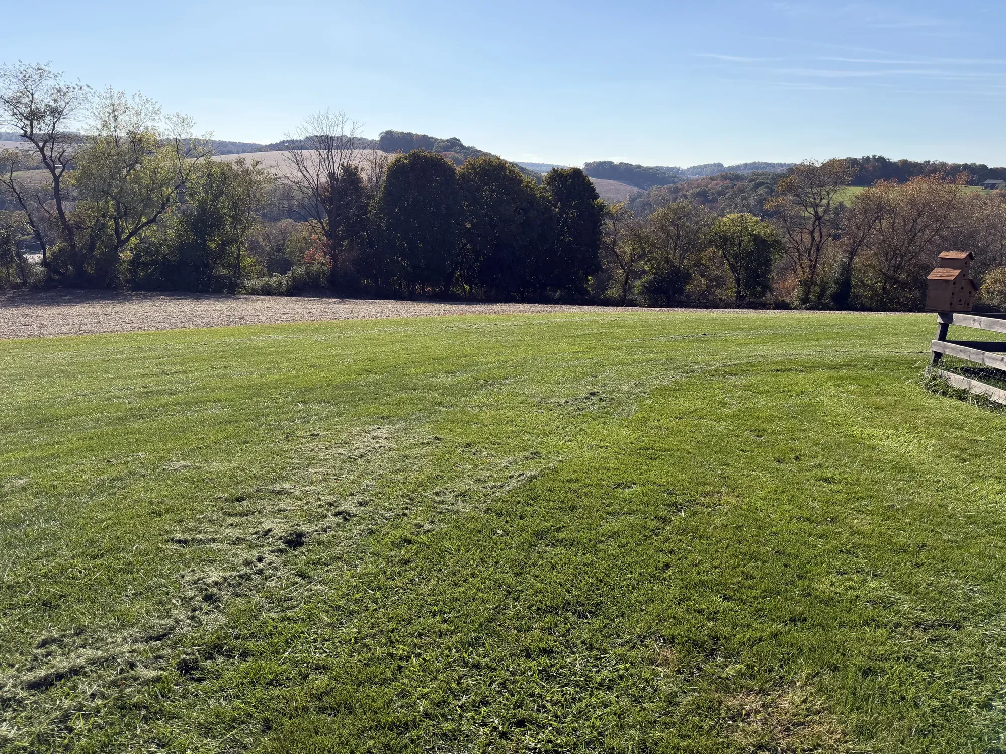 The mowed storage field on Mike's property in Felton, PA, with a wooden fence and the hills of southern York County behind