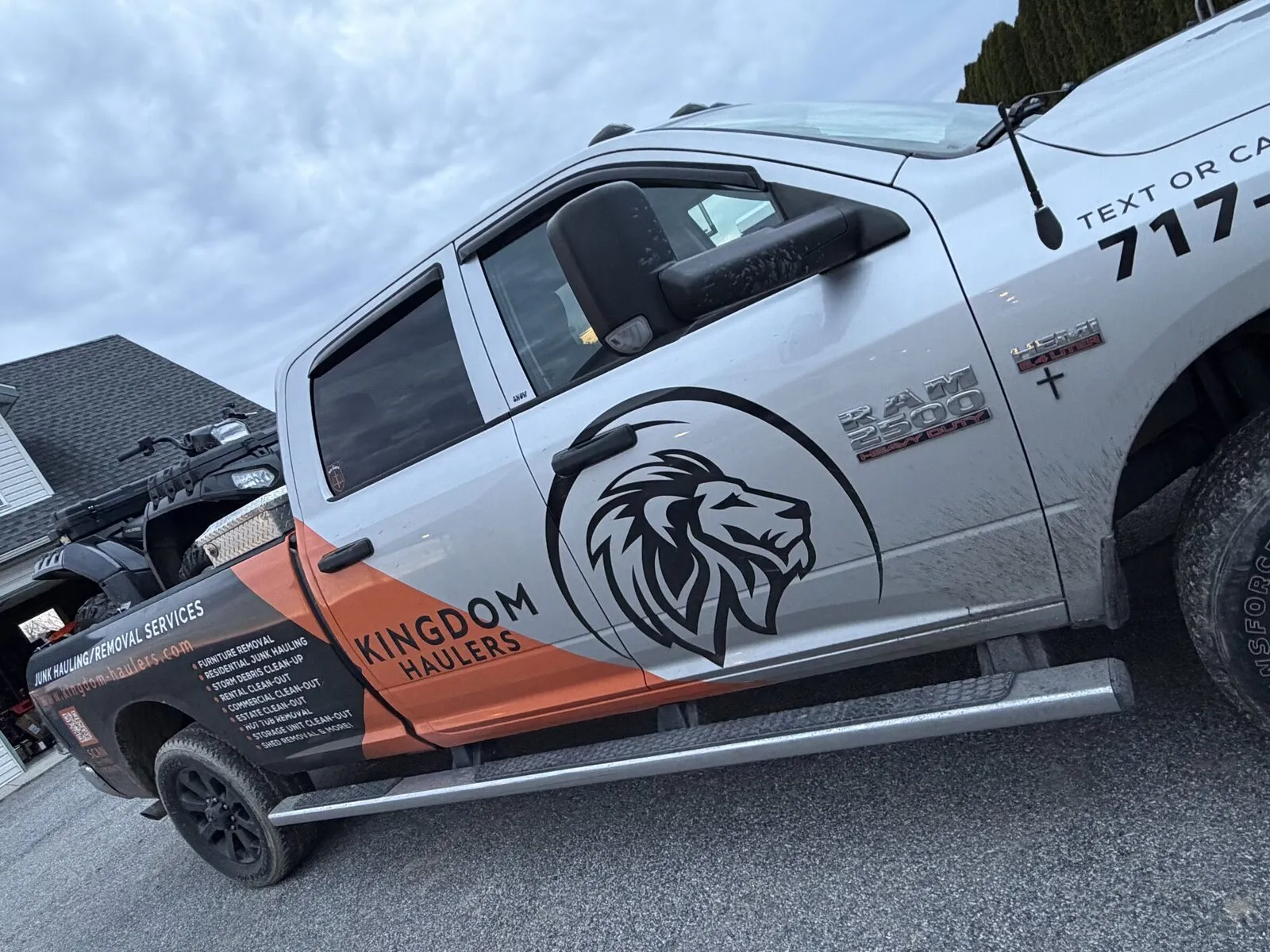 The Kingdom Haulers lion logo on the door of the company pickup